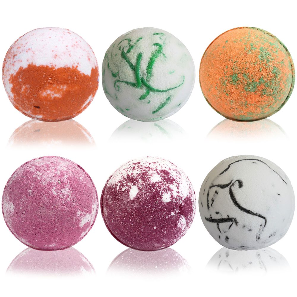 Six bath bombs, displaying various colors and patterns, rest on a white background.