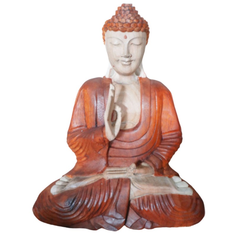 A wooden Buddha statue sits in a meditative pose with one hand raised in a gesture, wearing flowing robes. The background is plain, highlighting the figure's serene expression.