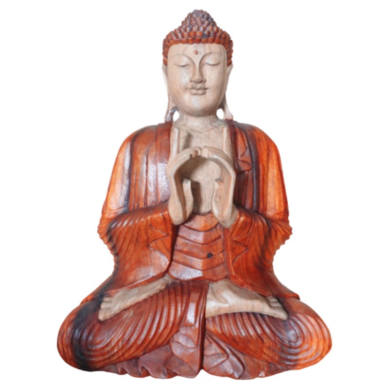 A wooden Buddha statue sits cross-legged, hands forming a gesture near the chest, eyes closed. It is carved with intricate details, displaying a calm and serene expression against a plain background.