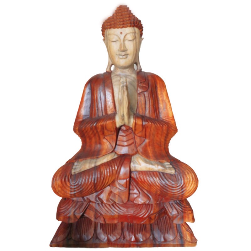 Wooden Buddha statue sits with hands in prayer, carved intricately with robes detailed, eyes gently closed, atop a simple, white background.