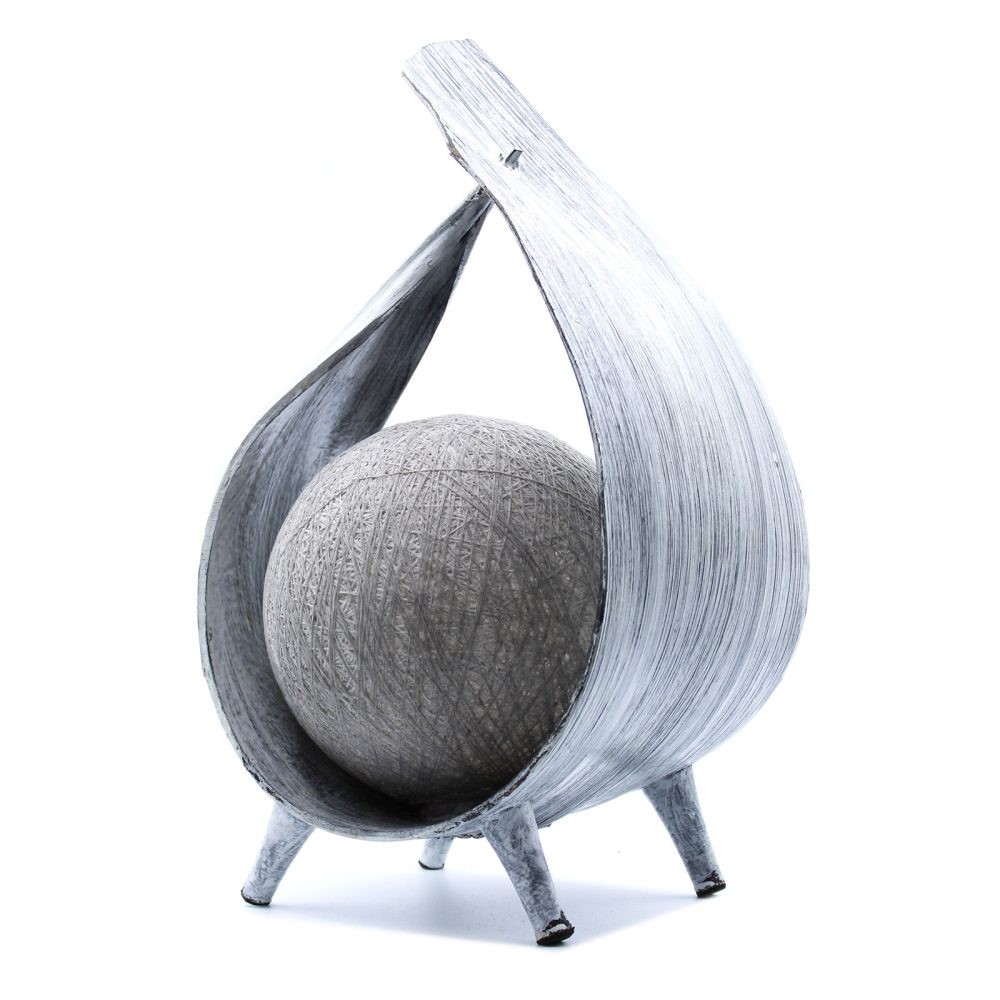 A gray sphere rests within a gray, stylized, leaf-shaped stand on three short legs against a white background.