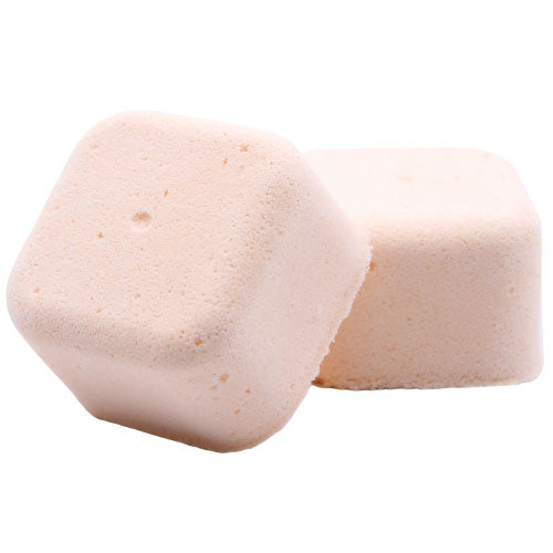 Two pale pink, cube-shaped blocks are stacked, one leaning slightly against the other, on a plain white background. They have a smooth, slightly rough texture.