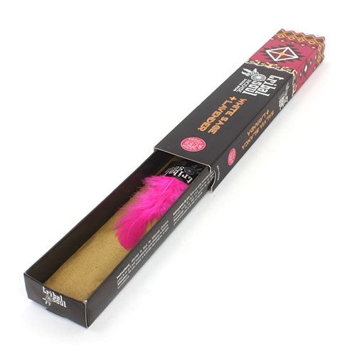 A rectangular black box titled "Holy Smokes Wildberry Incense Extra Rich" contains pink feathers and incense sticks. The colorful packaging features graphic designs and branding, with text emphasizing its aromatic richness.