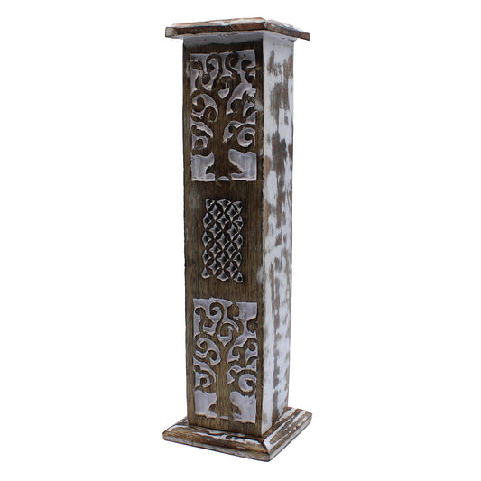 A tall, wooden incense holder stands upright, featuring intricate carvings and a weathered, whitewashed finish, set against a plain white background.