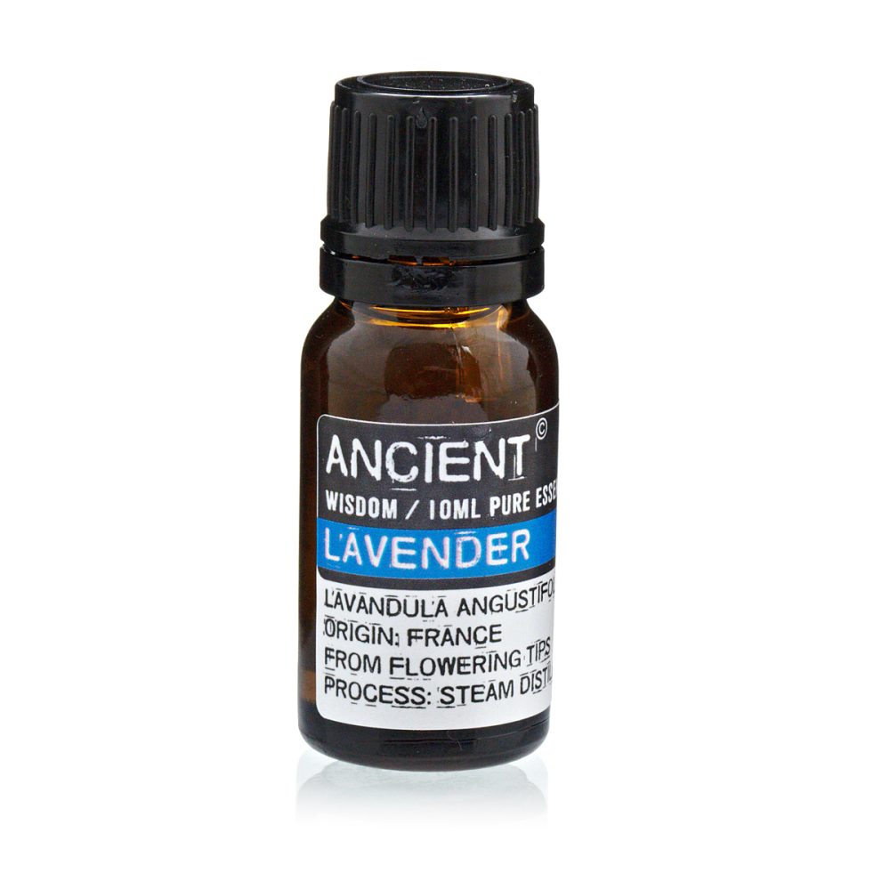 A dark glass bottle stands, filled with brown liquid and capped with black plastic. A label reads: "ANCIENT. WISDOM / 10ML PURE ESS. LAVENDER. LAVANDULA ANGUSTIFO. ORIGIN: FRANCE. FROM FLOWERING TIPS. PROCESS: STEAM DIST."