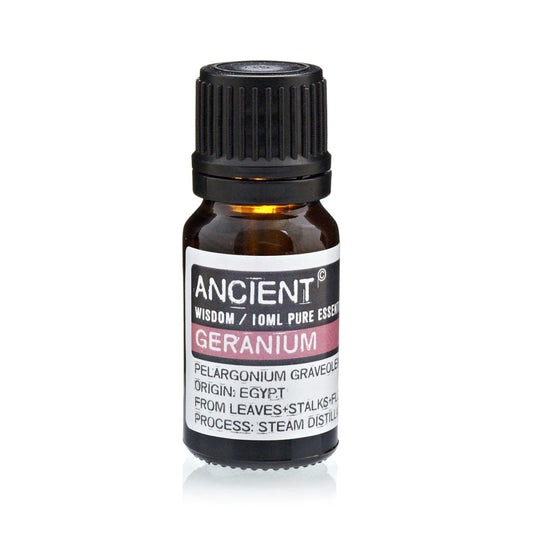 A bottle of essential oil sits on a white surface. The label reads: "ANCIENT," "WISDOM / 10ML PURE ESSENCE," "GERANIUM," "PELARGONIUM GRAVEOLE," "ORIGIN: EGYPT," "FROM LEAVES+STALKS+FL," and "PROCESS: STEAM DISTILL".