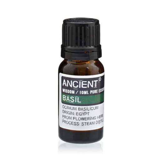 A glass bottle of "ANCIENT WISDOM / 10ML PURE ESSEN - BASIL (OCIMUM BASILICUM; ORIGIN: EGYPT; FROM FLOWERING HERB; PROCESS: STEAM DISTILL)" sits against a bright, white background.