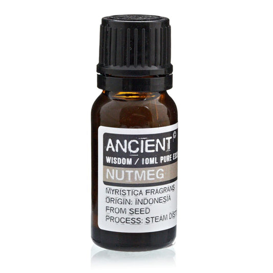 A brown glass bottle labeled "ANCIENT WISDOM / 10ML PURE ESS NUTMEG," sits on a reflective white surface. Text also details: "MYRISTICA FRAGRANS ORIGIN: INDONESIA FROM SEED PROCESS: STEAM DIST".