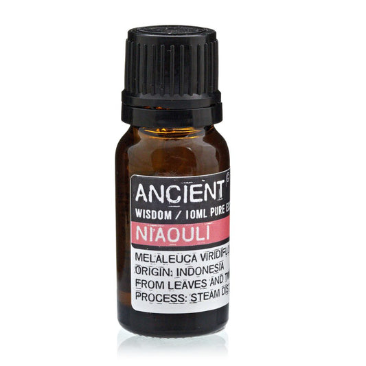 A small, amber bottle is standing, labeled "ANCIENT WISDOM / 10ML PURE ES," "NIAOULI," "MELALEUCA VIRIDIFLO," "ORIGIN: INDONESIA," "FROM LEAVES AND TH," and "PROCESS: STEAM DIS."