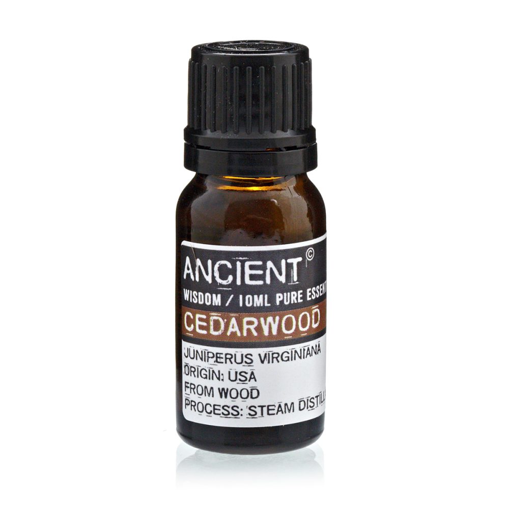A dark brown glass bottle with a black cap is centered, the label reads: "ANCIENT WISDOM / 10ML PURE ESSEN CEDARWOOD JUNIPERUS VIRGINIANA ORIGIN: USA FROM WOOD PROCESS: STEAM DISTILL".