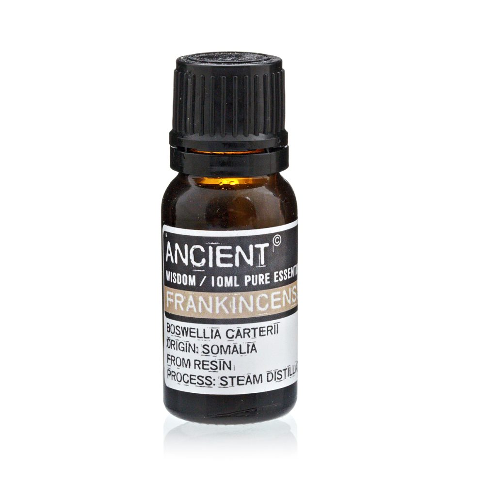 A dark glass bottle sits upright, labeled "ANCIENT WISDOM / 10ML PURE ESSENT FRANKINCENS BOSWELLIA CARTERII ORIGIN: SOMALIA FROM RESIN PROCESS: STEAM DISTILL."
