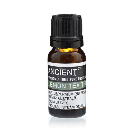 A small bottle of "ANCIENT" lemon tea tree essential oil sits upright on a white surface. The label reads "WISDOM / 10ML PURE ESSENTIAL, LEPTOSPERMUM PETERSON, ORIGIN: AUSTRALIA, FROM LEAVES, PROCESS: STEAM DISTILLATION".