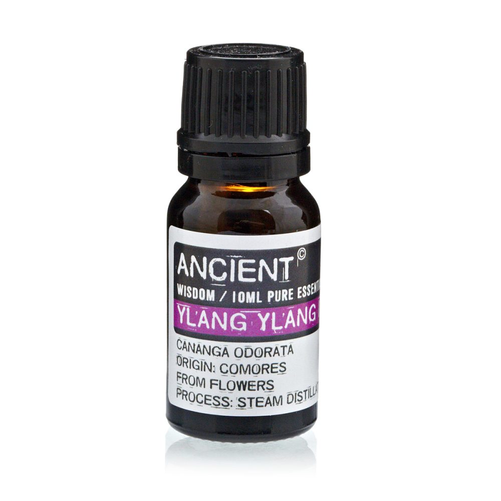 A small brown glass bottle with a black cap contains "ANCIENT WISDOM / 10ML PURE ESSENT YLANG YLANG CANANGA ODORATA ORIGIN: COMORES FROM FLOWERS PROCESS: STEAM DISTILL".