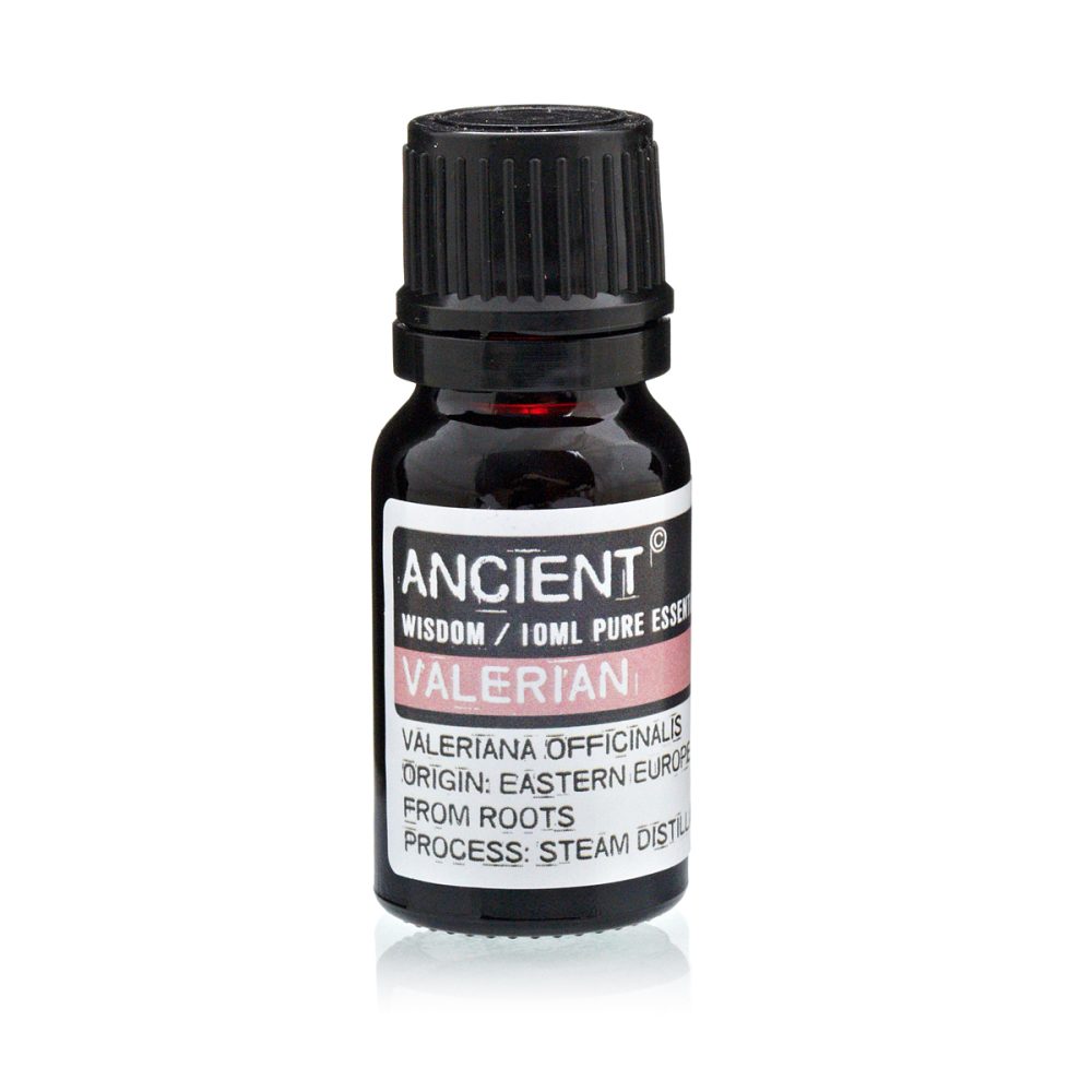 A bottle of "Ancient Wisdom" Valerian essential oil sits still. Its label reads, "Valeriana Officinalis, Origin: Eastern Europe, From Roots, Process: Steam Distill."