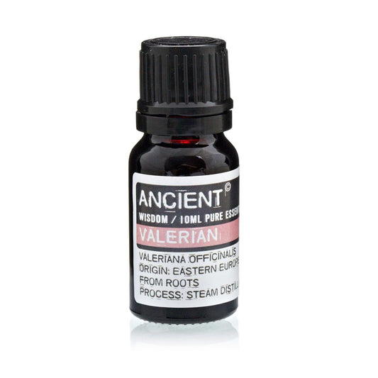 A bottle of "Ancient Wisdom" Valerian essential oil sits still. Its label reads, "Valeriana Officinalis, Origin: Eastern Europe, From Roots, Process: Steam Distill."