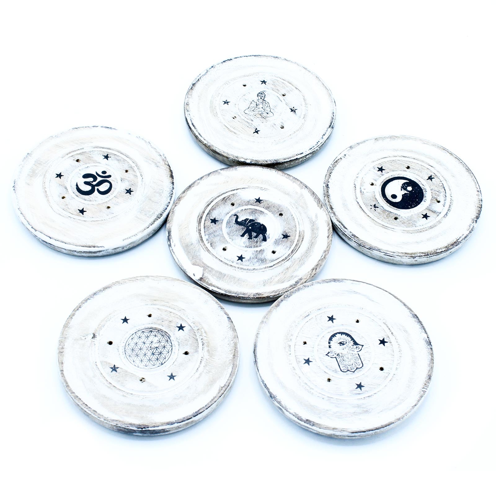 Decorative wooden coasters display symbols like Om, elephant, yin-yang, Buddha, flower of life, and hamsa hand, each surrounded by stars, against a white background.