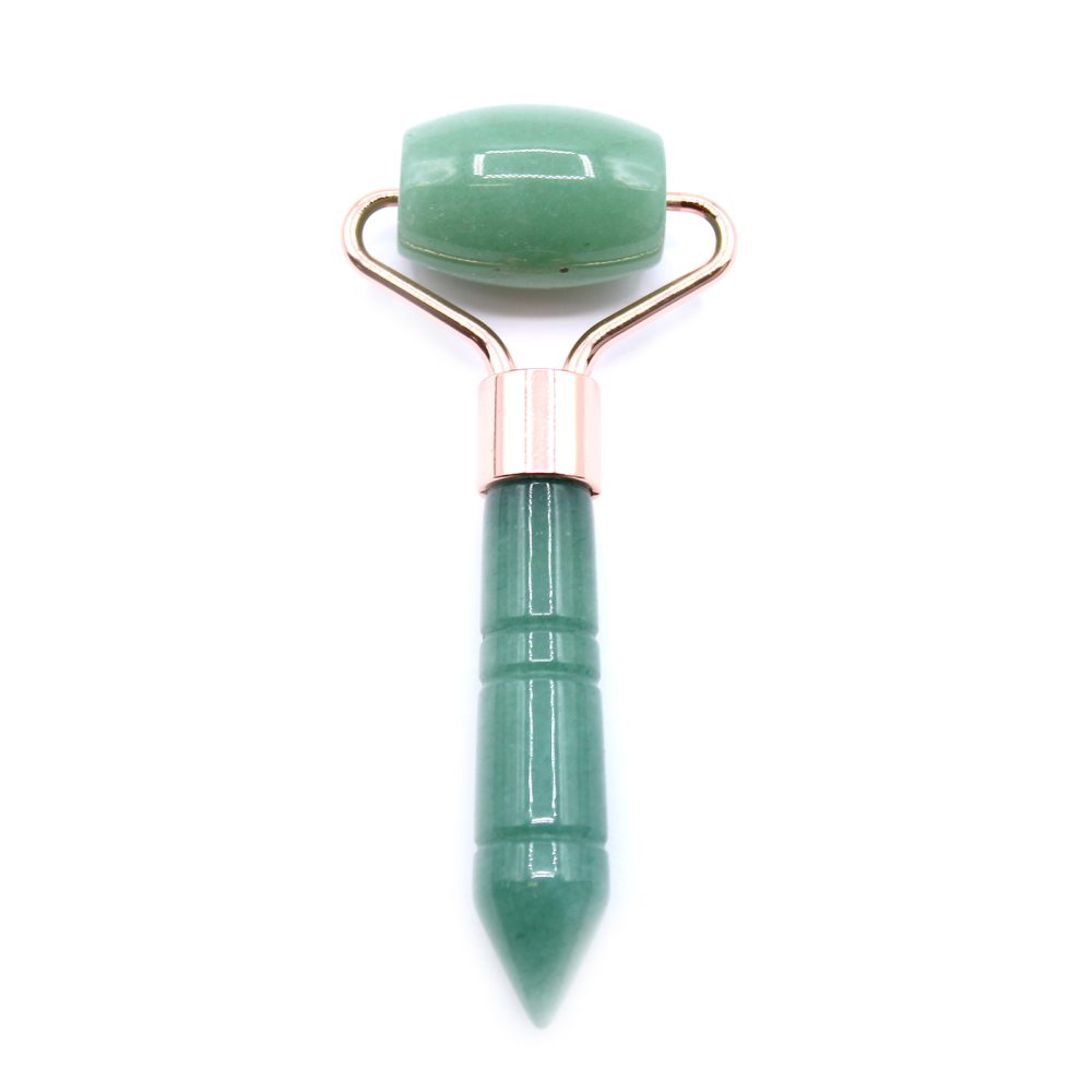 A jade roller with a green head and handle and gold-colored metal connecting pieces is presented upright against a plain white background.