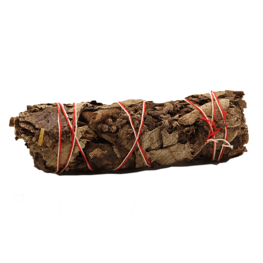 A bundle of dried leaves is wrapped tightly with red and white string. The bundle sits horizontally against a solid green background.