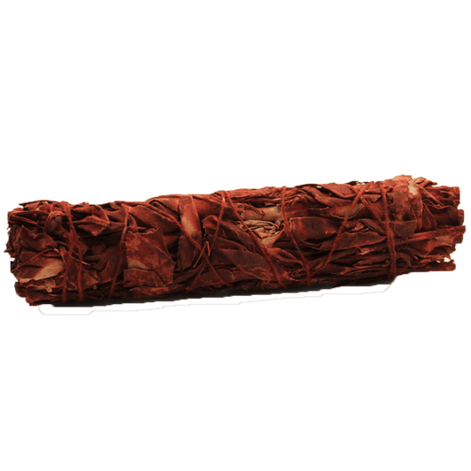 A tightly-bound smudge stick of dry, reddish leaves lies horizontally in the center of a solid green background. Twine secures the leaves, giving it a brick-like shape.