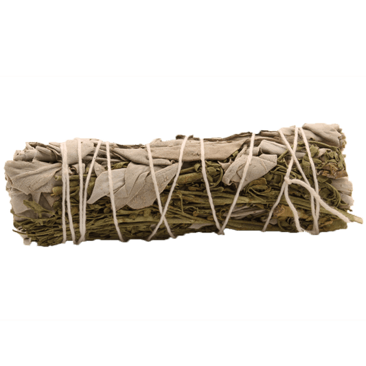 A sage bundle wrapped tightly with white string sits on a dark green background.