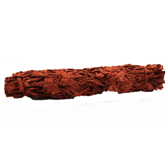 A tied bundle of brown leaves rests on a light surface, casting shadows. The backdrop is a solid, dark green color.