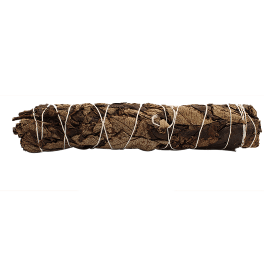 A bundle of brown leaves is tightly secured with white string. The bundle sits horizontally against a solid green background.