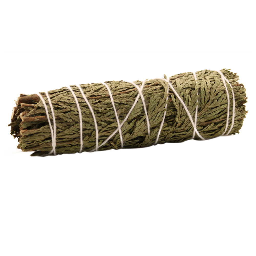 Bundled cedar, tied with white string, sits horizontally on a white background.