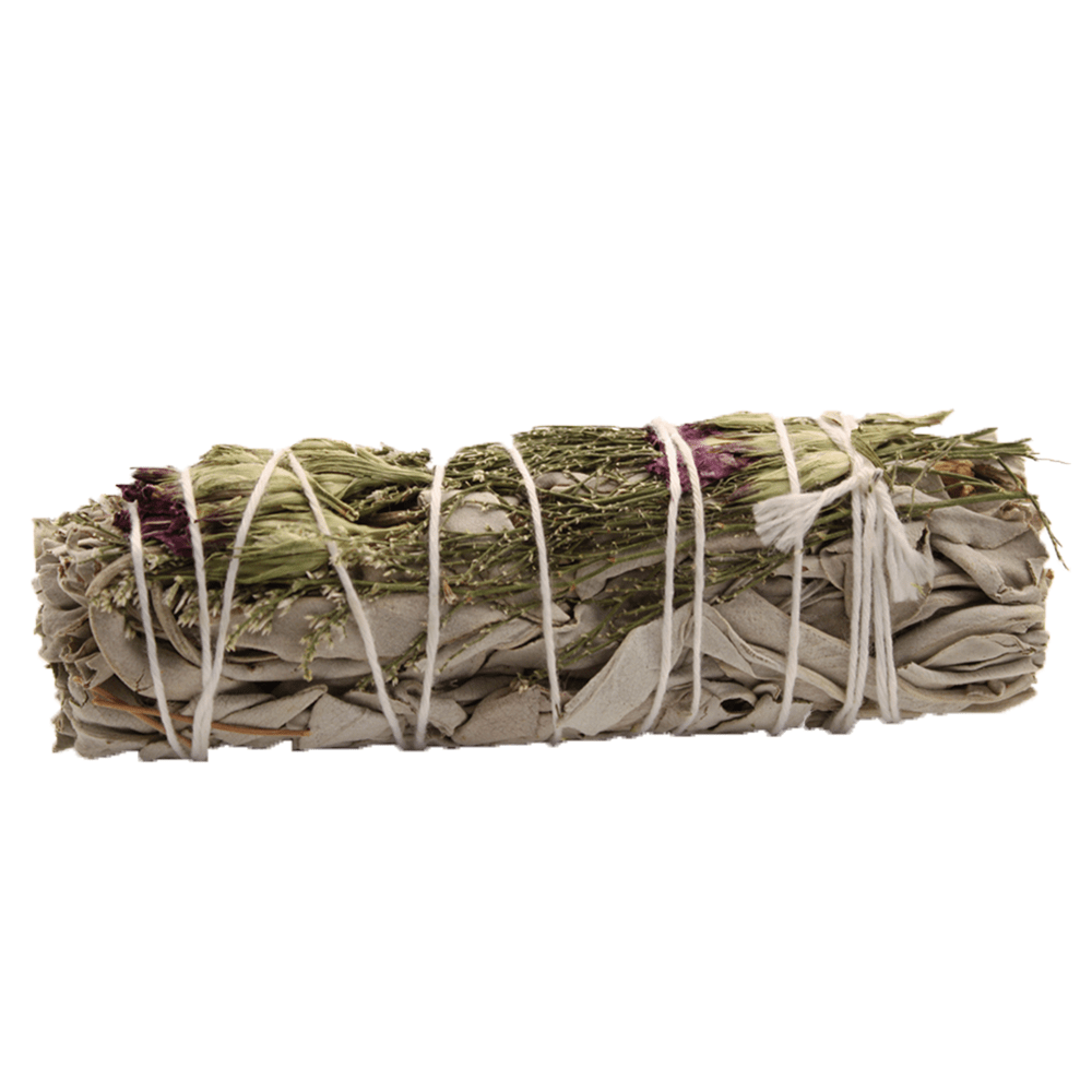 The sage bundle sits, tightly wound with white string, surrounded by white.