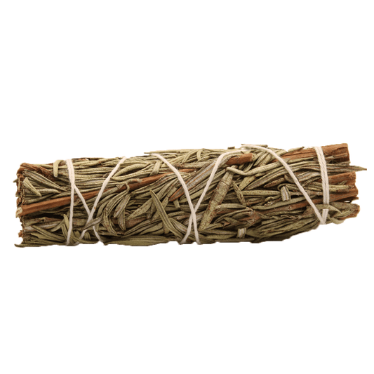Aromatic herb bundle, mostly rosemary, is tied with white string. It sits on a white surface.