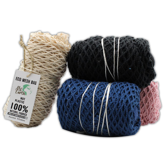 Several mesh bags, secured with string, sit in a stack. Colors include beige, black, blue and pink. The beige bag has a tag that reads "ECO MESH BAG, ALW Earth NOT PLASTIC, 100% NATURAL FABRICS www.cottonnotplastic.com Ancient Wisdom".