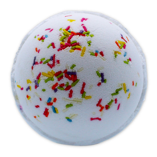 A white spherical bath bomb is covered in colorful sprinkles, resembling a festive decoration, isolated against a plain white background.