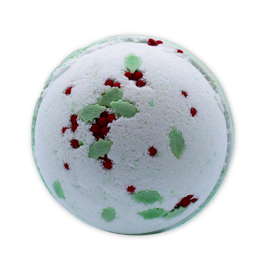 A spherical white bath bomb, adorned with green leaves and small red berry-like decorations, rests against a plain white background.
