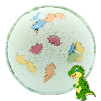 A spherical bath bomb features embedded colorful dinosaur shapes on a light green surface. A cartoon dinosaur is illustrated at the lower right corner, enhancing a playful, dinosaur-themed design.