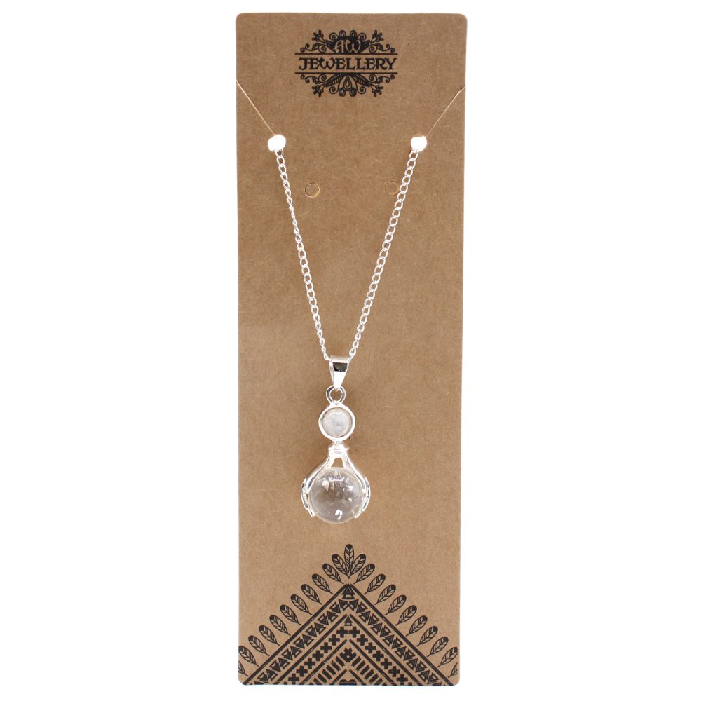 A silver chain necklace featuring moonstone and clear quartz is displayed on a tan jewelry card. "JEWELLERY" is printed in fancy font at the top. An ethnic pattern design appears at the bottom.