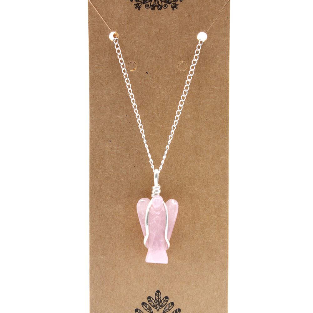 A pink, crystal-like angel pendant hangs from a silver chain. It rests on a brown, cardboard display card.