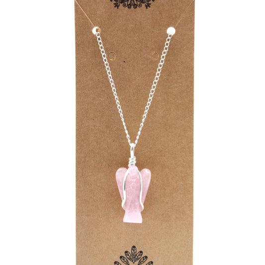 A pink, crystal-like angel pendant hangs from a silver chain. It rests on a brown, cardboard display card.