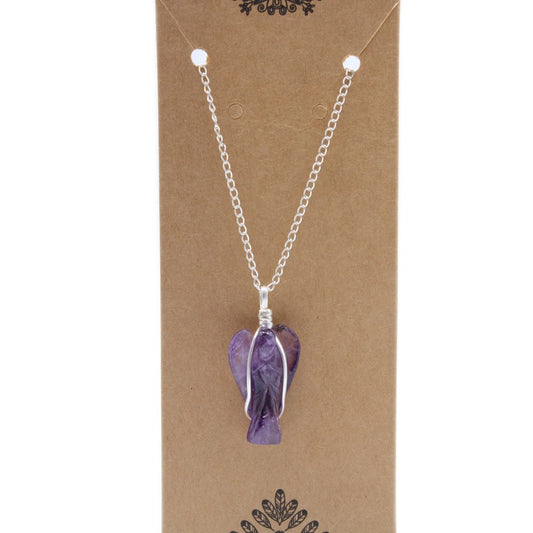 A purple, angel-shaped crystal pendant hangs from a silver chain on a brown cardboard display, ready for purchase.