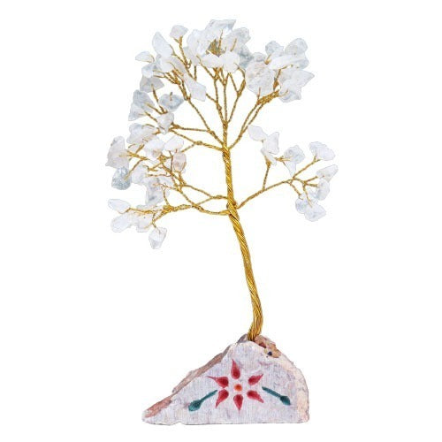 A tree made of gold wire and quartz crystals grows from a rock featuring a red flower design with green leaves, against a white background.