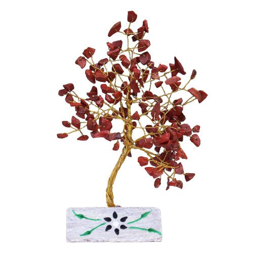 A decorative tree, with a gold wire trunk and branches, displays red gemstone leaves. The tree sits on a rectangular stone base decorated with a stylized flower design.