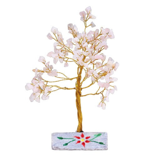 A small, decorative, crystal tree made of gold wire and pale pink crystals stands on a grey, rectangular base painted with a red and green flower. The background is white.