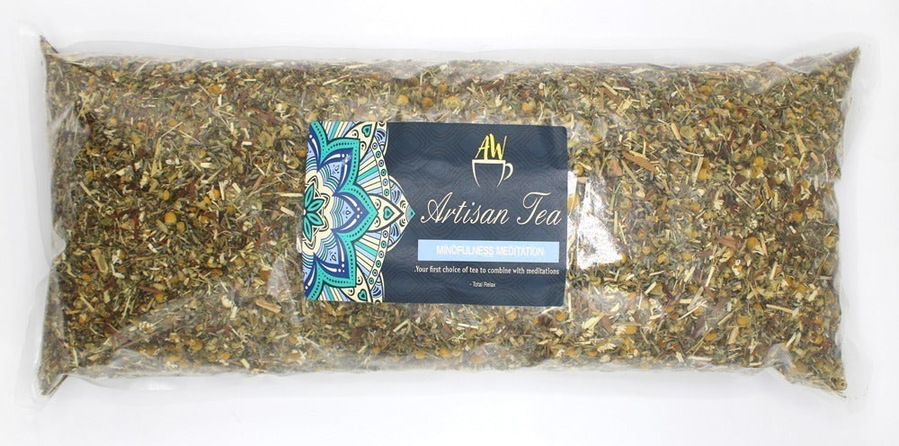 A clear plastic bag holds loose leaf tea with a label reading: "AW Artisan Tea Mindfulness Meditation. Your first choice of tea to combine with meditations." It features a colorful mandala design.