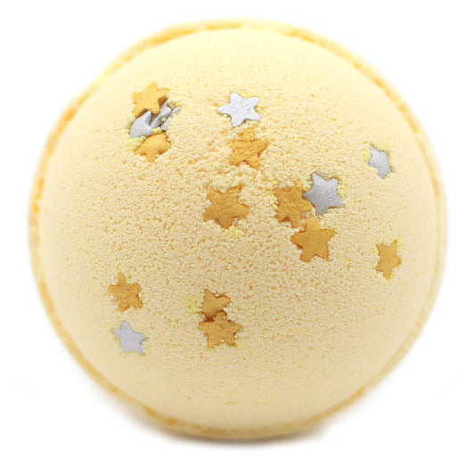 A yellow bath bomb is decorated with small gold and silver star-shaped sprinkles, set against a plain white background.