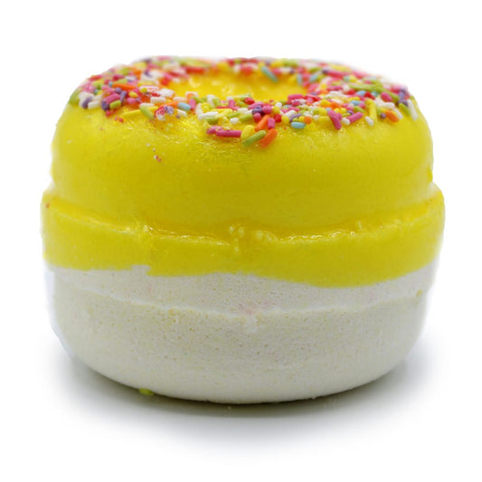 A vibrant, yellow doughnut-shaped object topped with colorful sprinkles is sitting on a white surface. It has a layered appearance, combining bright yellow and white sections.
