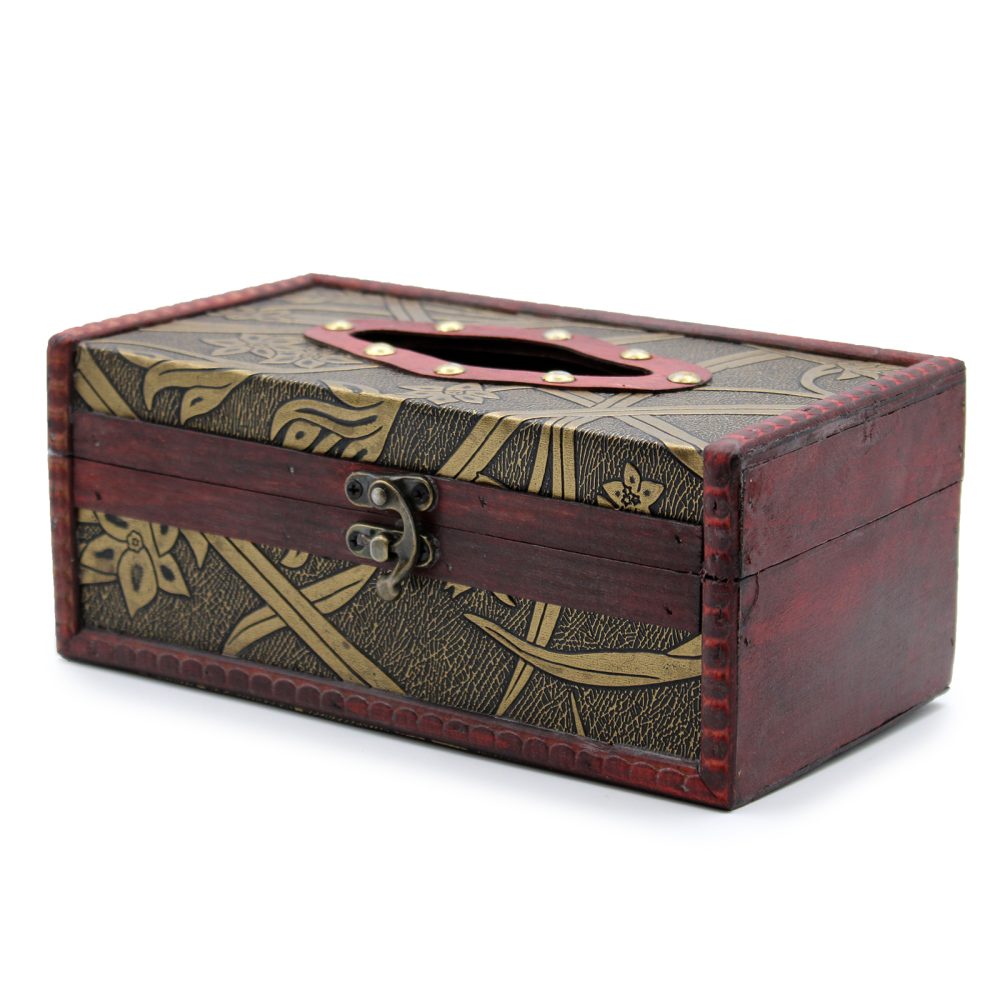 A rectangular tissue box, made of wood with brass embellishments and floral designs, features a top opening and a front latch, placed against a white background.