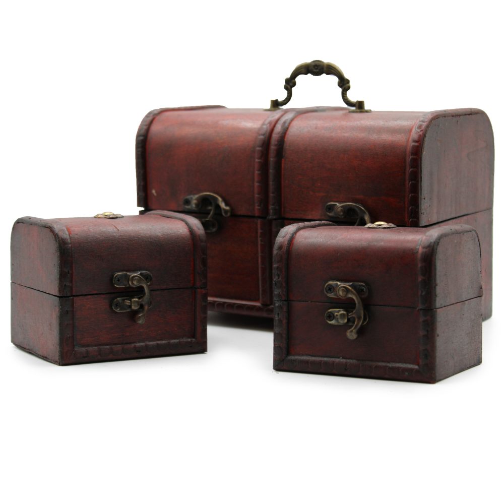 Three small, decorative wooden chests with ornate metal clasps, arranged in a group on a plain, white surface. The largest chest features a metal handle on top.
