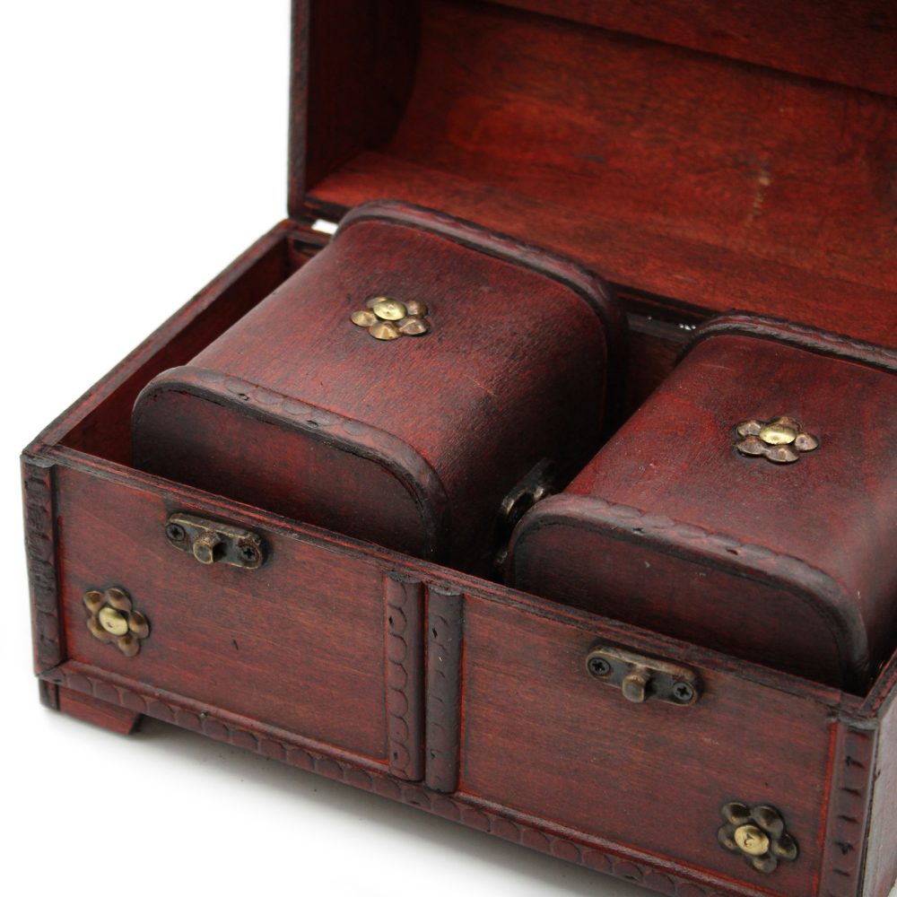Wooden box with a hinged lid is open, displaying two smaller wooden containers inside. Each container is adorned with ornate metal flower decorations. The box rests on a neutral surface.