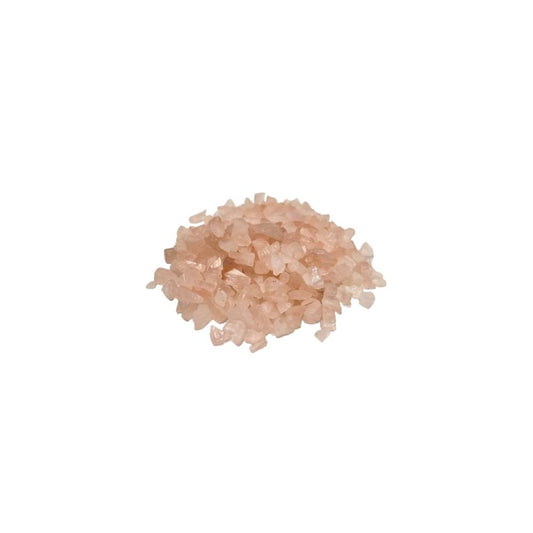 A pile of pale pink, translucent crystal fragments sits against a stark white background. The crystals vary slightly in size and catch the light unevenly.