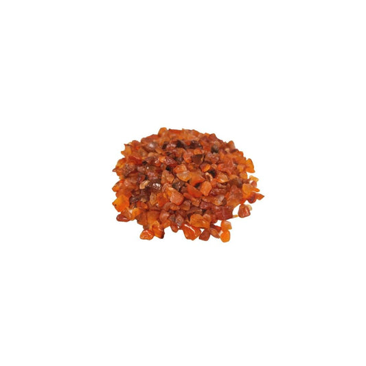 A pile of small, irregularly shaped, translucent orange and brown pieces sit still against a stark white backdrop.