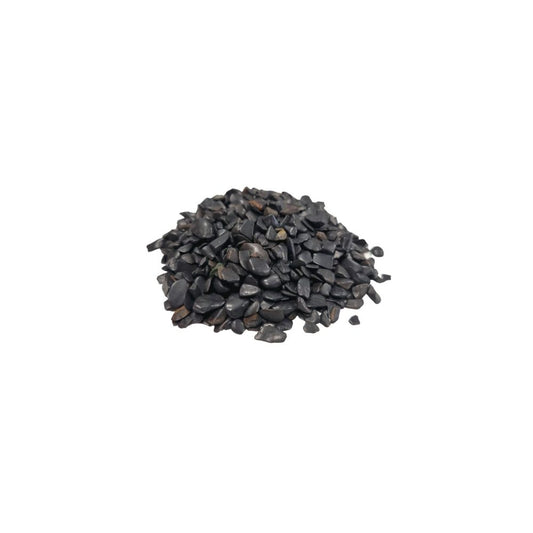 A heap of small, dark pebbles sit in a pile, their surfaces reflecting light, against a stark white background.