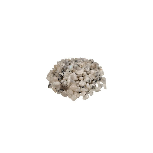A pile of small, light-colored rocks, many of which have dark flecks, sits in the center of a plain white background.